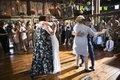Bride and groom dancing with parents at wedding reception
