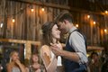 Bride and groom sharing first dance at barn wedding