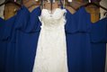 White lace bridal gown and wedding dresses arranged on hangars