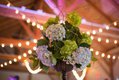 Closeup of floral centerpiece with bokeh lights in background