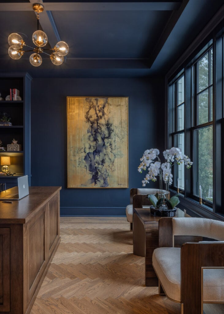 A dramatic gold painting in a blue office in an Upper Saucon house