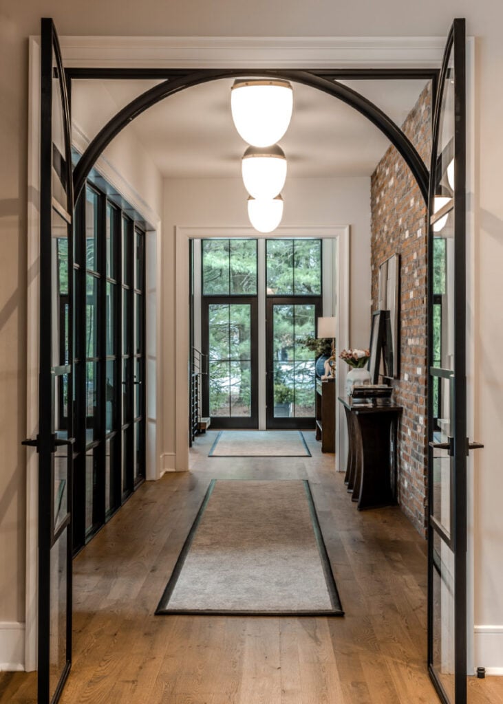 A glass and brick lined hallway in an Upper Saucon house